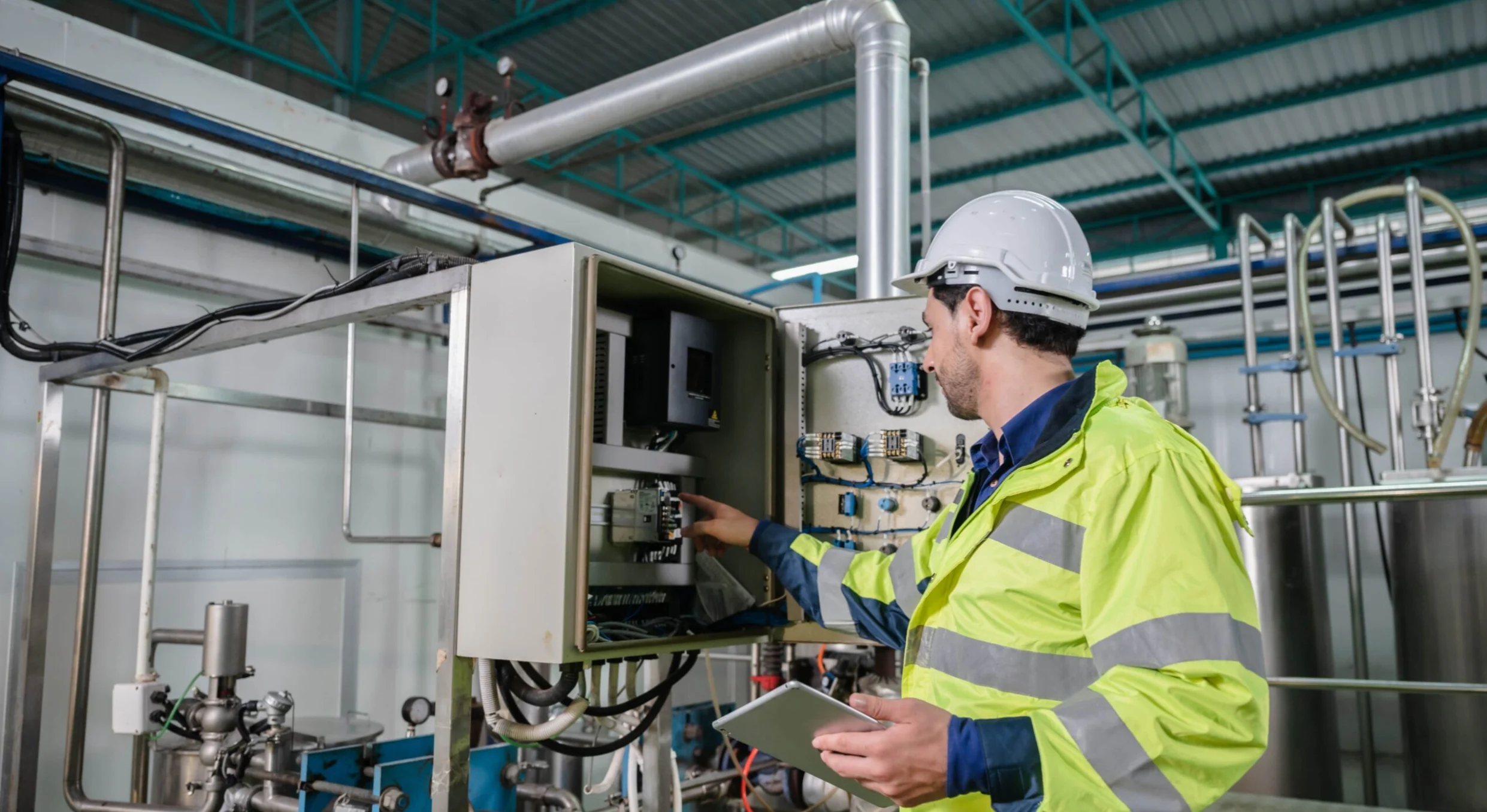 Industrial technician inspecting electrical controls