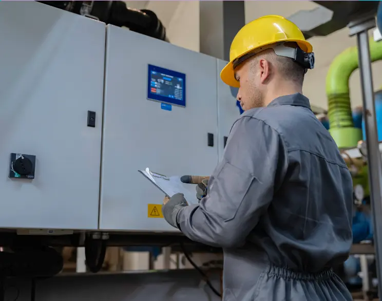 Professional technician inspecting an electrical control panel for NFPA 70B compliance